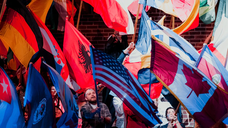 Students waving flags from different countries