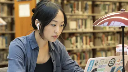 Woman studying on her computer in the library